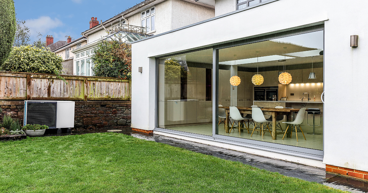 Heat Pump Week 12 CBH A Daikin heat pump in a garden of a renovated home